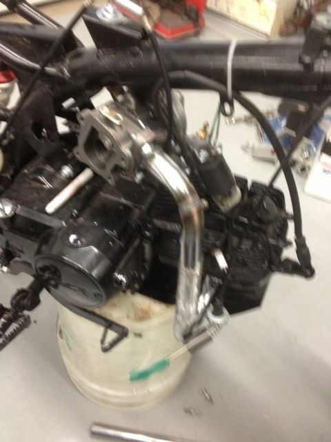 2003 Ford Crown Victoria - Close-up view of a motorcycle engine, showing the exhaust pipe and carburetor assembly.