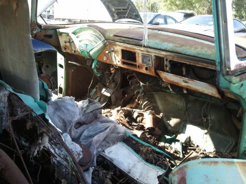 1994 Ford Bronco - Interior view of a heavily rusted 1955 Chevrolet Bel Air, showing significant interior damage and decay.