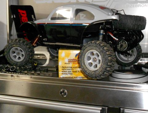 1996 Ford Bronco - This RC car is sitting on a toolbox next to a box of auto parts.