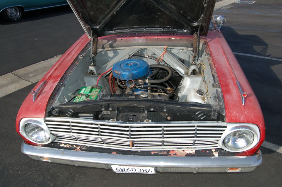Red 1963 Ford Ranchero with hood open showing engine, blue air cleaner, and plate 6W68384