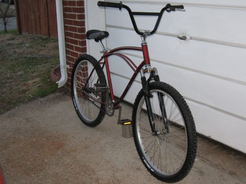 1994 Ford Bronco - This bicycle has a red frame, black handlebars, and knobby tires.