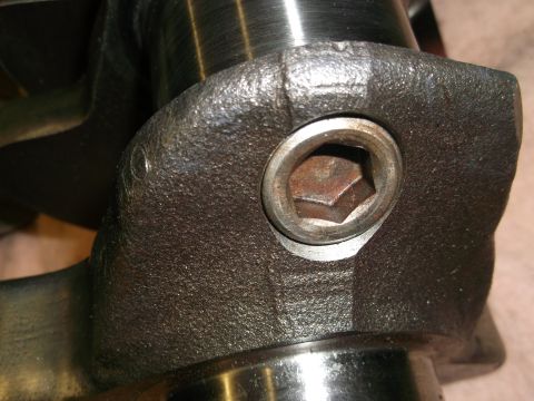 1965 Shelby Cobra - A close-up view of a bolt securing a crankshaft counterweight, showing its hex head.