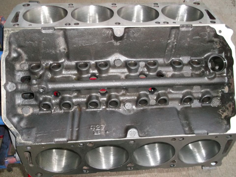 Bare V8 engine block casting marked 427 with eight bored cylinders, viewed from above