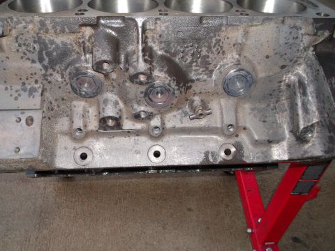 1965 Shelby Cobra - Close-up view of an engine block supported by red jack stands.