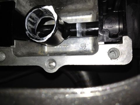 2013 Ford Mustang - Close-up view of a vehicle component, possibly a hose fitting, with sealant applied.