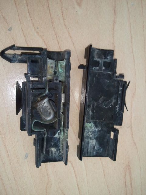 1994 Ford Bronco - This disassembled underhood light assembly shows significant corrosion on its metal parts.