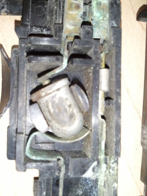 1994 Ford Bronco - Close-up view of a corroded underhood light socket, showing the internal electrical contacts.