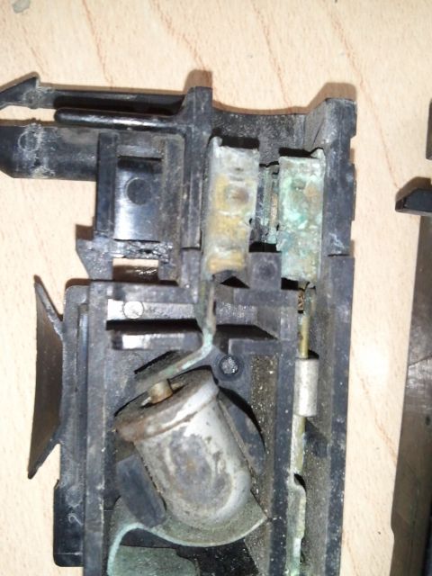 1994 Ford Bronco - Corroded electrical connector part, showing internal contacts and plastic casing.
