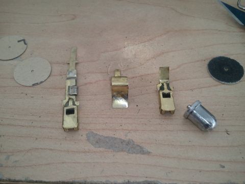 1994 Ford Bronco - Various electrical connectors and a bulb are laid out on a wooden surface.