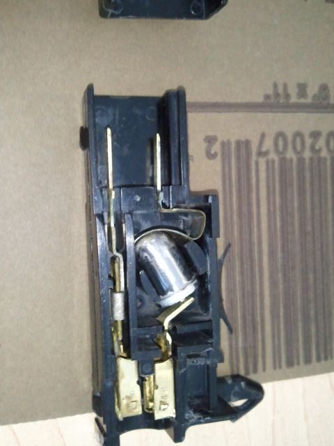 1994 Ford Bronco - Close-up view of an underhood light socket assembly, showing internal electrical contacts and the bulb mounting mechanism.