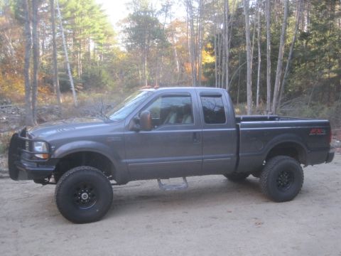 2003 Ford F-350 - Side view of a gray 2003 Ford F-350 Super Duty pickup truck parked outdoors.