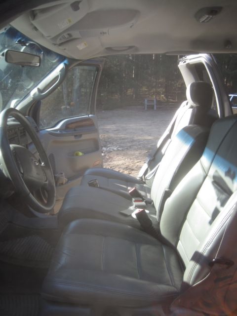 2003 Ford F-350 - The interior of a 2003 Ford F-350 pickup truck is shown, its front seating and dashboard area.