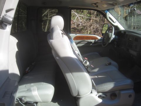 2003 Ford F-350 - Interior of a 2003 Ford F-350 pickup truck, showing the front and rear seating areas.