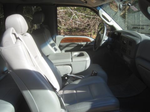 2003 Ford F-350 - Interior view of a 2003 Ford F-350, gray leather seats and wood trim accents on the door panel.