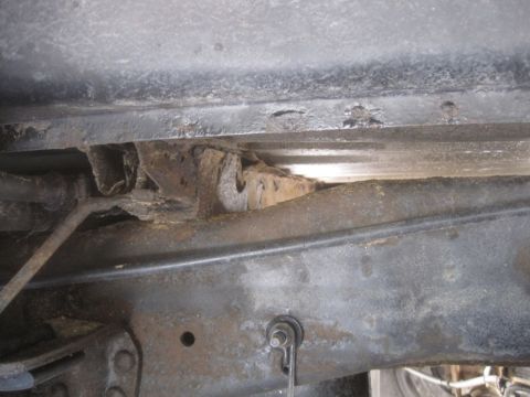 2003 Ford F-350 - Extensive rust and corrosion are visible on the truck's frame, indicating potential structural weakness.