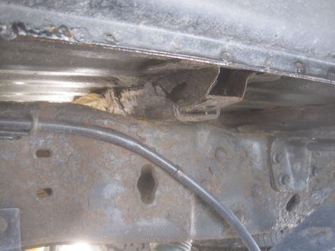 2003 Ford F-350 - Close-up of a heavily rusted truck frame, indicating potential structural compromise.