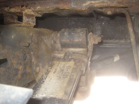 2003 Ford F-350 - Close-up of a heavily rusted leaf spring assembly, showing a part number tag.
