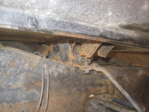 2003 Ford F-350 - Close-up view of corroded undercarriage components, showing significant rust and wear.