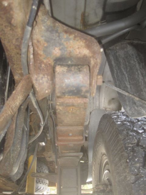 2003 Ford F-350 - Underside view of a 2003 Ford F-350 showing the leaf spring suspension and rear tire.