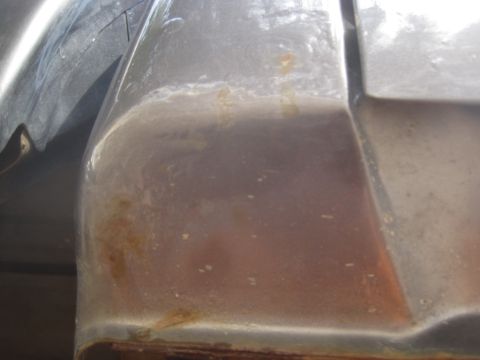 2003 Ford F-350 - Close-up view of rust forming on the rear fender of a vehicle.