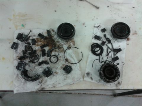 1996 Ford Bronco - Various gears, seals, and housing components from a differential are spread out on paper towels for inspection or repair.