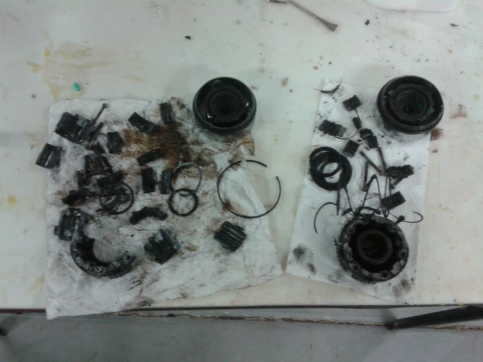Disassembled differential parts laid out on paper towels