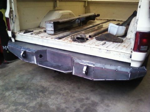 1989 Ford Bronco - Custom steel bumper on a pickup truck bed with metal parts inside.