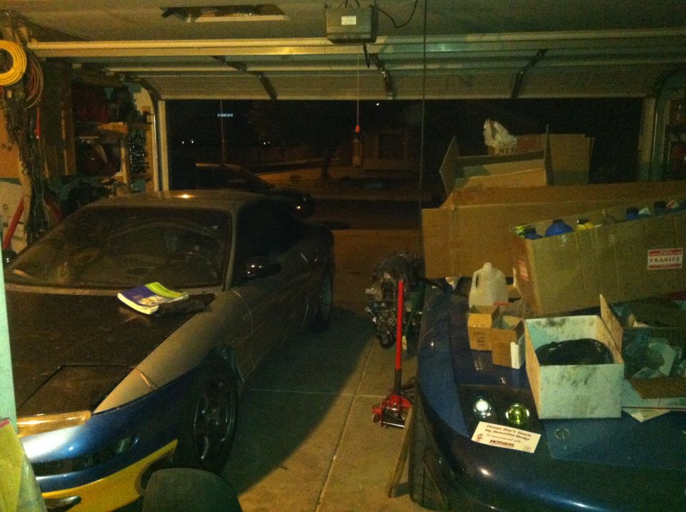 Dark blue and yellow 1995 Ford Probe parked in a garage, front 3/4 view