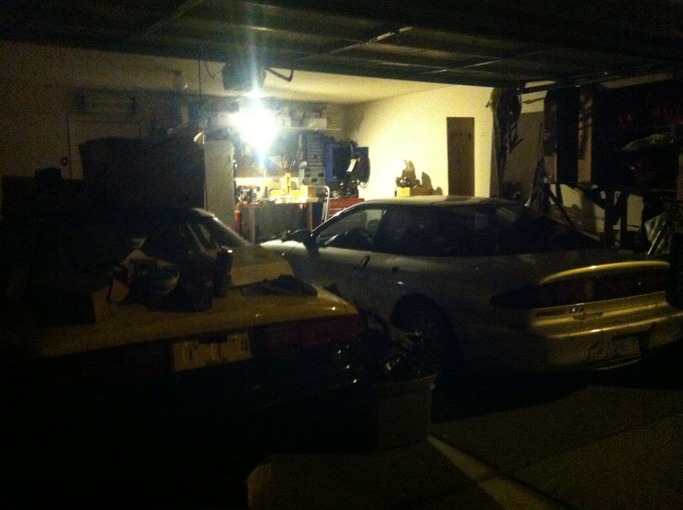 Rear view of a white 1995 Ford Probe in a garage