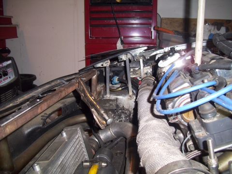 1995 Ford Probe - A close-up view of a car's engine bay shows modifications and active welding work.