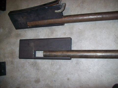 1988 Ford Bronco - Two metal bars with rectangular housings are shown, one secured with a clamp.