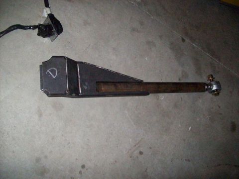 1988 Ford Bronco - A single metal suspension arm with a 'D' marking is shown on a concrete surface.