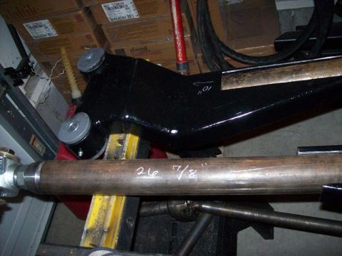 1988 Ford Bronco - A black suspension arm with markings is shown alongside a metal rod also marked with measurements.