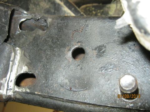 1970 Ford Bronco - A close-up view of a damaged metal component, possibly part of a vehicle's chassis, with a visible date stamp.