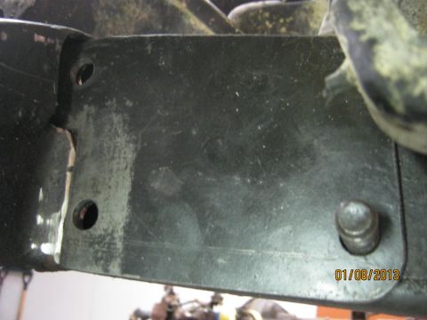 1970 Ford Bronco - A close-up view of a metal bracket, likely part of a vehicle's steering mechanism, shows wear and tear.