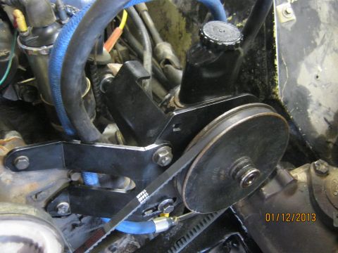 1970 Ford Bronco - Close-up view of a power steering pump and pulley system, showing the belt and associated hoses.