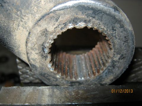 1970 Ford Bronco - Close-up view of a splined metal part, possibly a shaft or connector, secured in a vise.