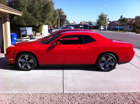 2010 Dodge Challenger - A red Dodge Challenger is parked in front of a garage on a sunny day.