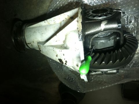 1985 Toyota Pickup/SR5 - Close-up of a vehicle differential assembly, showing internal gears and a green tool.