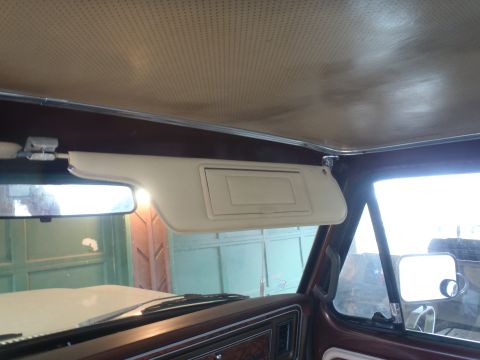 1979 Ford Bronco - The interior of a 1978 Ford Bronco is visible, with a focus on the sun visor and dashboard details.