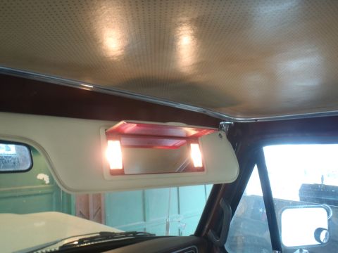 1979 Ford Bronco - Illuminated vanity mirror and beige headliner visible inside the 1979 Ford Bronco.