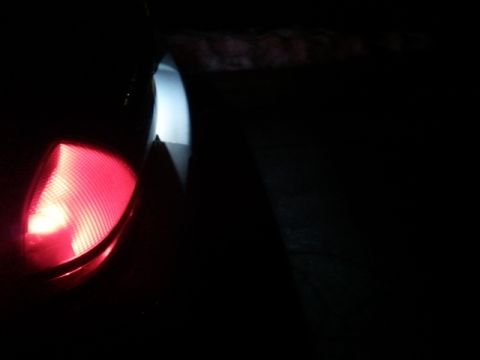 2008 Mercury Grand Marquis - A close-up of a vehicle's red taillight is visible against a dark background.