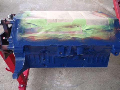 1965 Shelby Cobra - Engine block being prepped for painting, resting on a red engine stand.