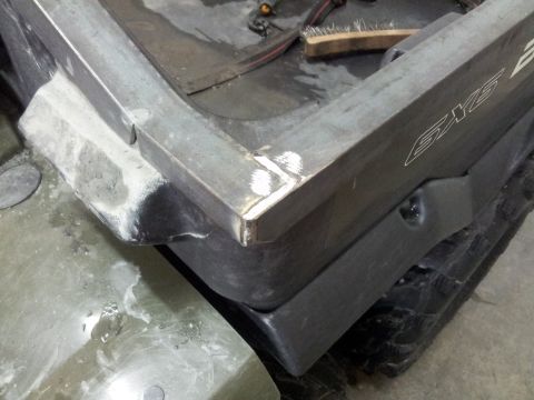 1990 Chevrolet Suburban - Close-up of an ATV's metal frame and plastic body, showing a 'SKY' logo.