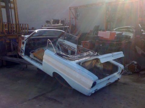 1964 Ford Ranchero - The light blue 1964 Ford Ranchero convertible body sits in a workshop, awaiting restoration.