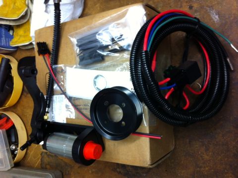 2010 Dodge Challenger - A collection of automotive parts, including a fuel pump and wiring, are laid out on a surface.