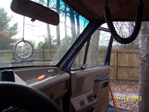 1990 Ford Bronco - The interior of a 1990 Ford Bronco is visible, including the dashboard and door panel.