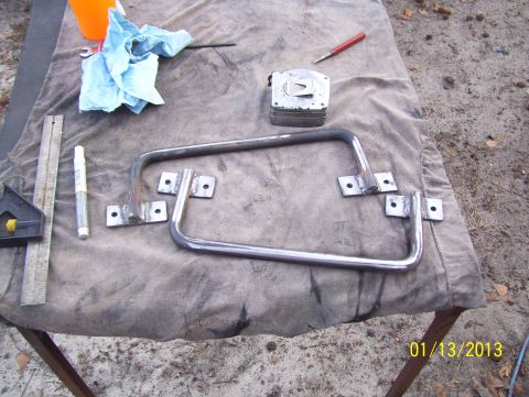 1990 Ford Bronco - Custom metal grab handles are laid out on a table with tools, ready for installation.