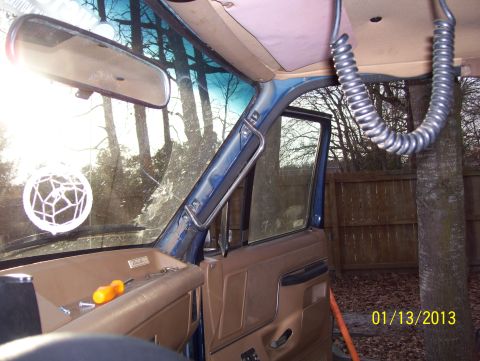 1990 Ford Bronco - Interior view of a 1990 Ford Bronco, focusing on the grab handle and dashboard area.