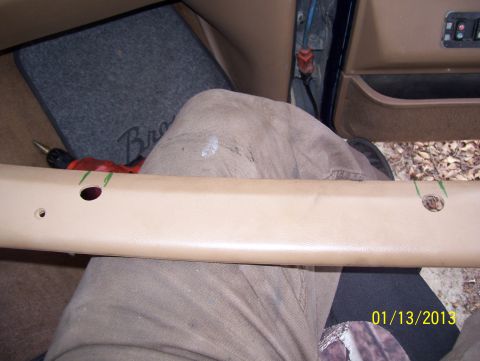 1990 Ford Bronco - Interior trim piece and floor mat with 'Bronco' text, along with a drill.